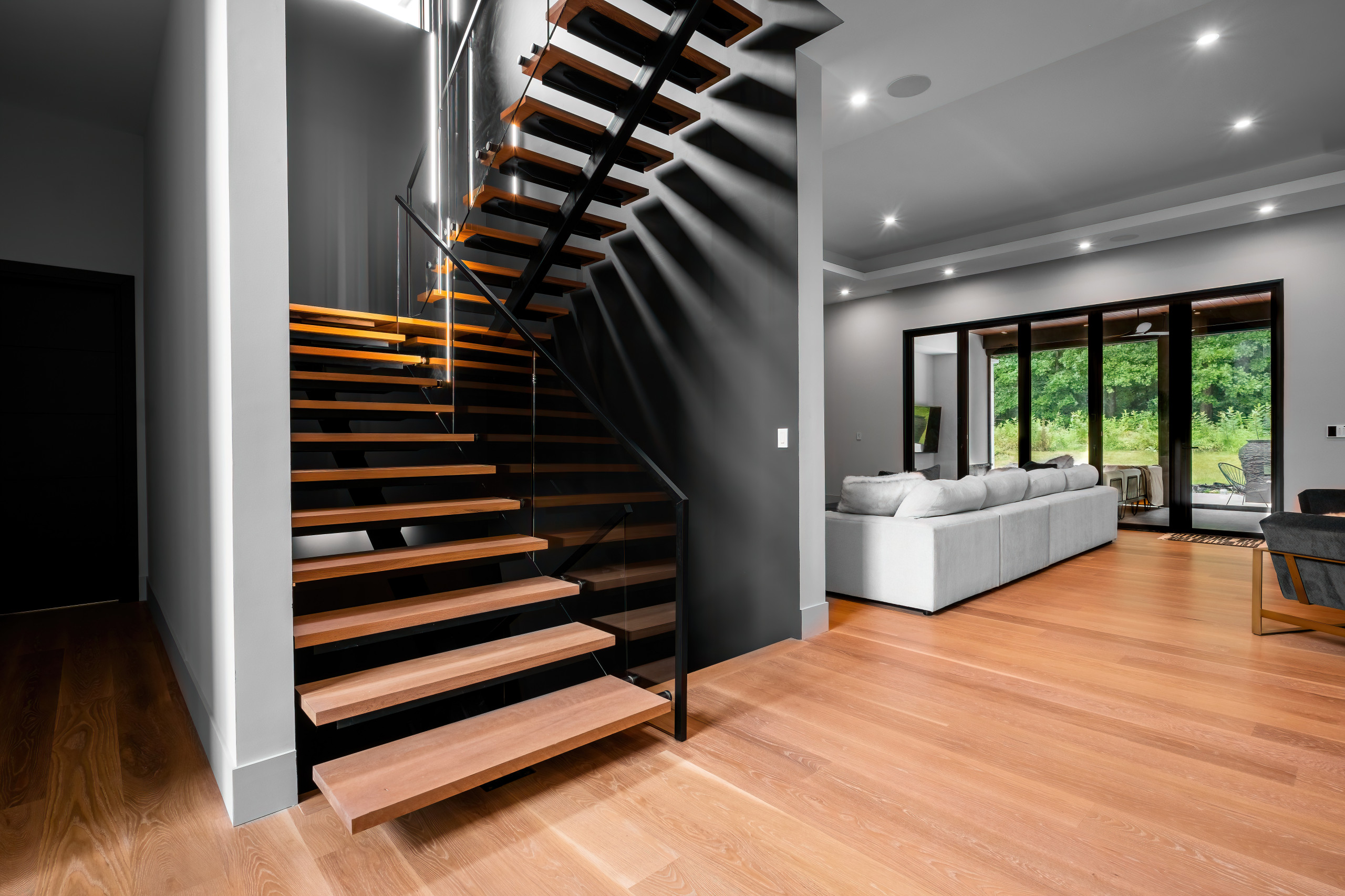 Custom mono stringer staircase with glass railing by NG Metal Fabrication