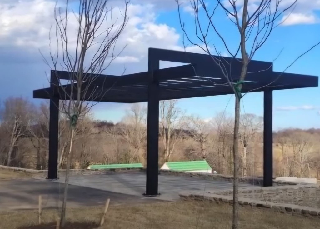 Custom aluminum pergola in an outdoor landscape